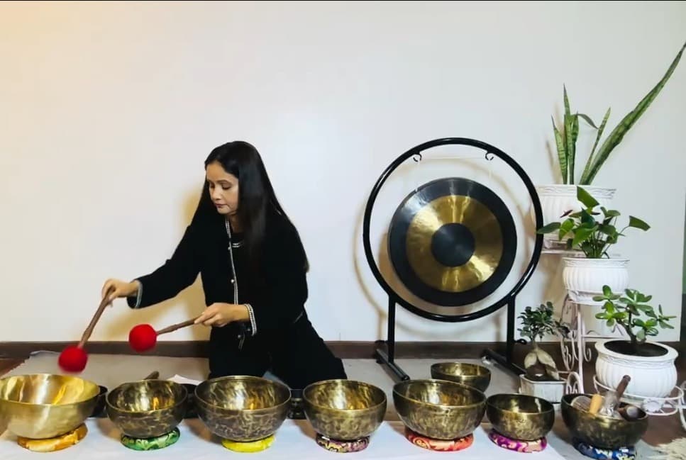 Group sound healing session with singing bowls and gong at Aarogya Man